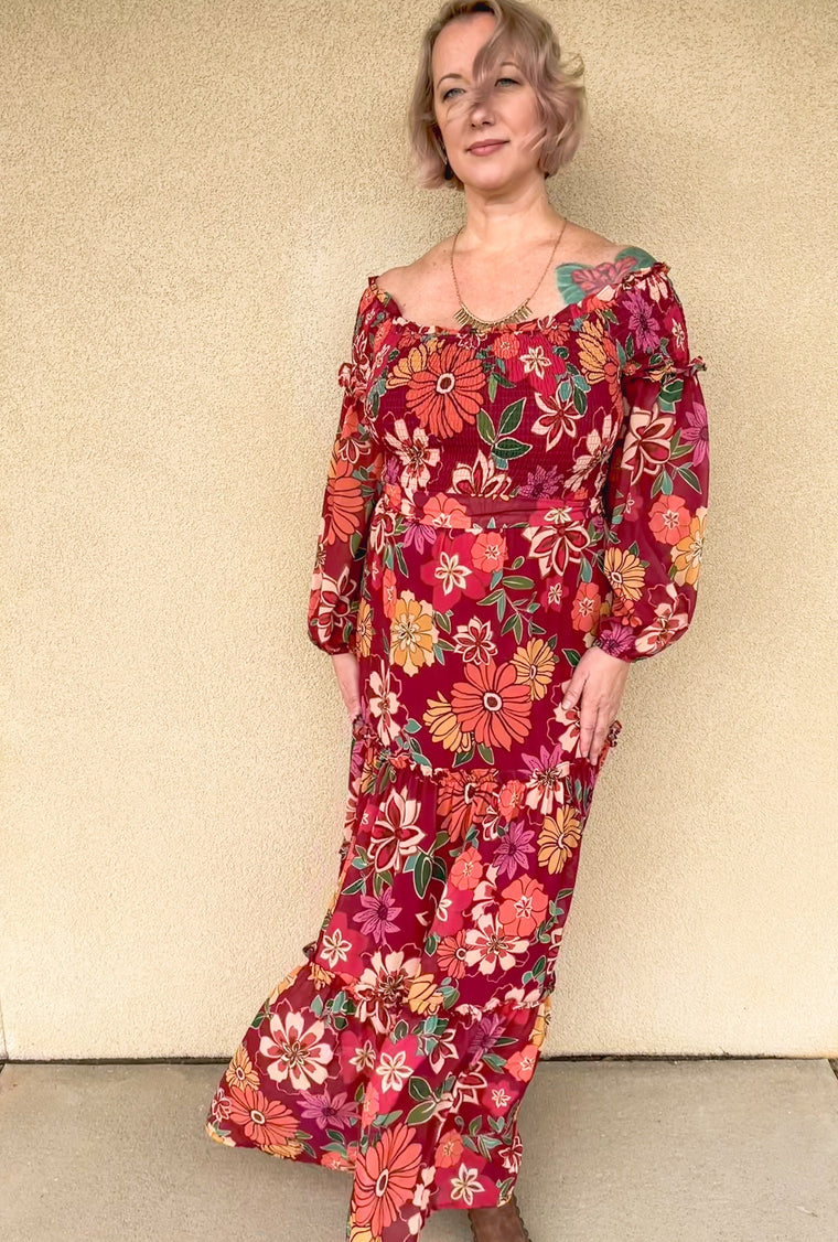 Be the apple of every admirer's eye with this flirty fall maxi dress. From the elastic waistband and tiered ruffles to the off-the-shoulder sheer sleeves to the smocked bustline, you'll be blossom-ing with style. So pick your petals and show 'em you deserve all the attention in this showstopper!  100% Polyester model is 5'6" 